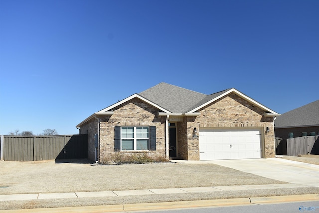 single story home featuring a garage, brick siding, and fence