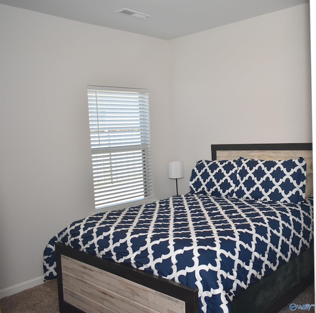 bedroom featuring carpet flooring, visible vents, and baseboards