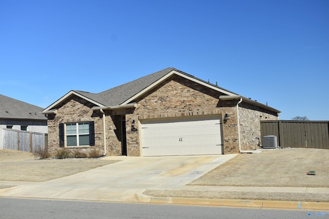 ranch-style home with driveway, an attached garage, fence, central air condition unit, and brick siding