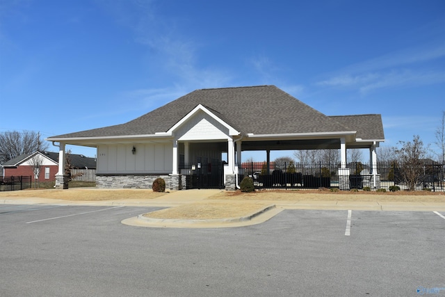 view of community featuring uncovered parking and fence