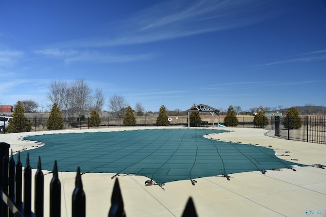 community pool featuring a patio area and fence