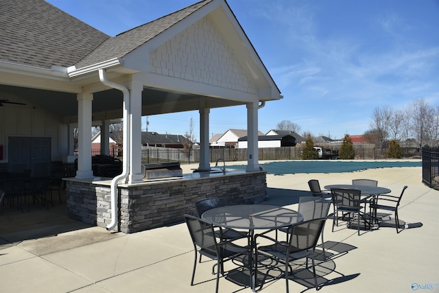 view of patio featuring outdoor dining area and fence