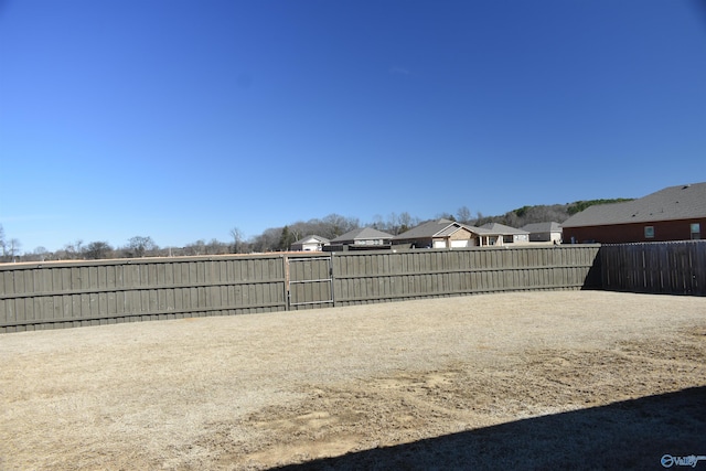 view of yard with a residential view and fence