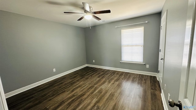 empty room featuring dark wood-type flooring and ceiling fan