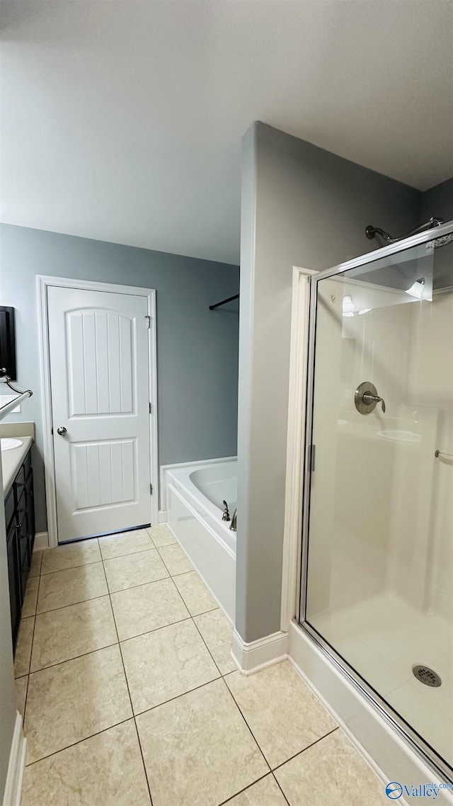 bathroom with independent shower and bath, vanity, and tile patterned floors