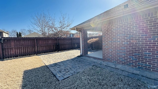 view of gate with a patio area