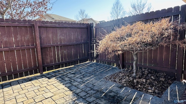 view of gate with a patio area