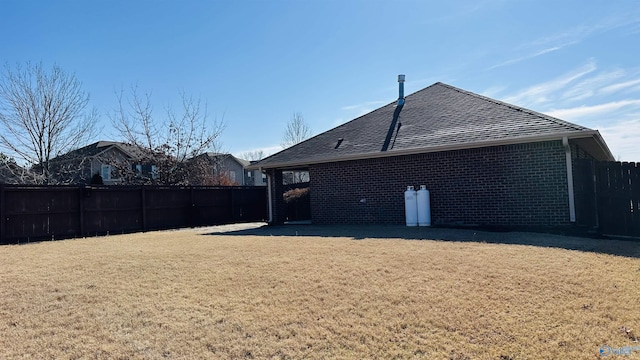 rear view of property with a yard