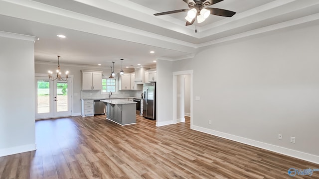 15685 Huntsville Brownsferry Rd, Athens, AL 35611 - kitchen with appliances with stainless steel finishes, ceiling fan with notable chandelier, ornamental molding, and a center island