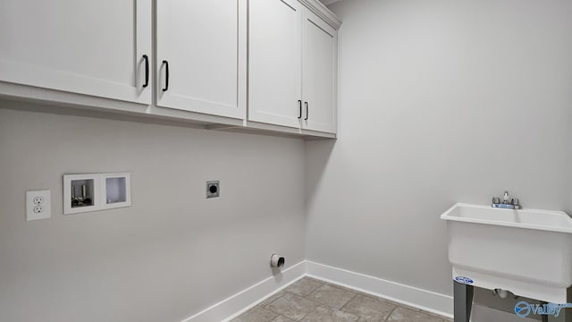 15685 Huntsville Brownsferry Rd, Athens, AL 35611 - clothes washing area with a sink, cabinet space, washer hookup, electric dryer hookup, and baseboards