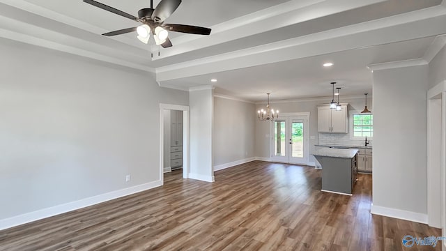 15685 Huntsville Brownsferry Rd, Athens, AL 35611 - unfurnished living room with recessed lighting, dark wood-style flooring, baseboards, ornamental molding, and ceiling fan with notable chandelier