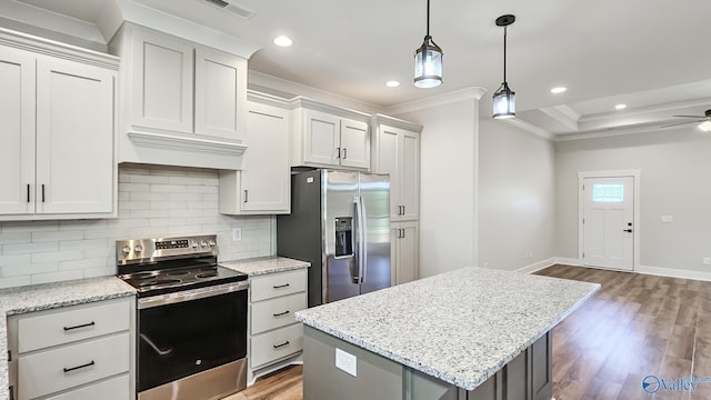 15685 Huntsville Brownsferry Rd, Athens, AL 35611 - kitchen with stainless steel appliances, a center island, light wood-type flooring, ornamental molding, and backsplash