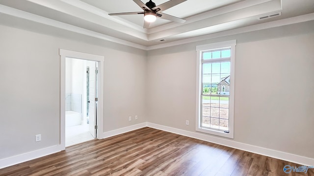 15685 Huntsville Brownsferry Rd, Athens, AL 35611 - unfurnished room with visible vents, ceiling fan, a tray ceiling, baseboards, and dark wood-type flooring