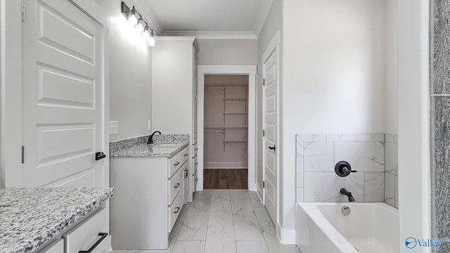 15685 Huntsville Brownsferry Rd, Athens, AL 35611 - full bath featuring a tub, ornamental molding, vanity, marble finish floor, and a walk in closet