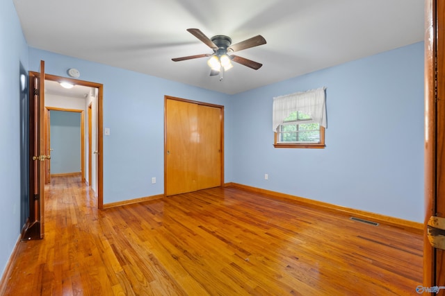 113 Gordon Dr, Athens, AL 35611 - unfurnished bedroom with hardwood / wood-style flooring, a closet, baseboards, and ceiling fan