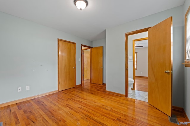 113 Gordon Dr, Athens, AL 35611 - unfurnished bedroom with light wood-style flooring, baseboards, and ensuite bathroom