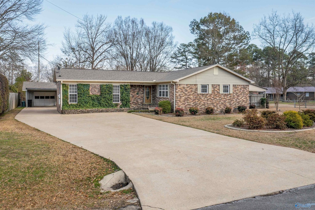 ranch-style house with a garage and a front lawn