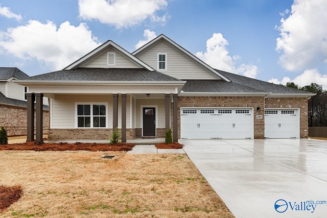 view of front of house featuring a porch and a garage