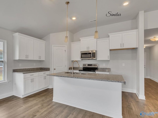 kitchen with stainless steel appliances, an island with sink, and white cabinets