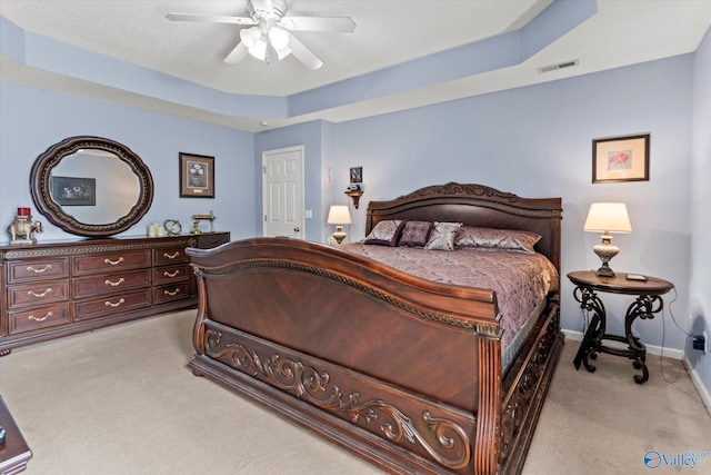 194 Bonaire Dr, Huntsville, AL 35811 - bedroom featuring light colored carpet, baseboards, a raised ceiling, and a ceiling fan