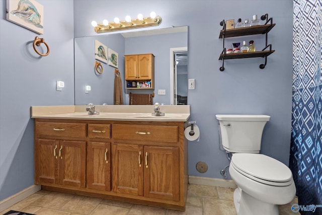 194 Bonaire Dr, Huntsville, AL 35811 - full bathroom with double vanity, baseboards, and toilet