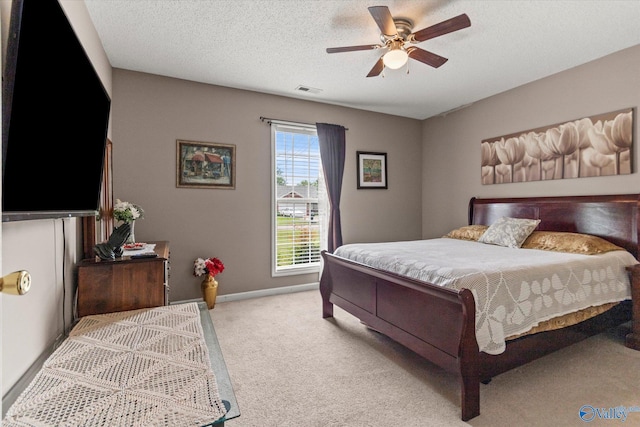 194 Bonaire Dr, Huntsville, AL 35811 - bedroom with light carpet, a ceiling fan, a textured ceiling, and baseboards