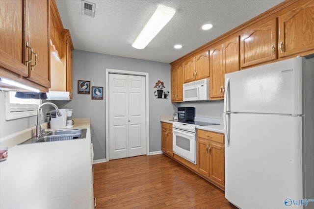 194 Bonaire Dr, Huntsville, AL 35811 - kitchen with white appliances, a sink, light countertops, wood finished floors, and recessed lighting