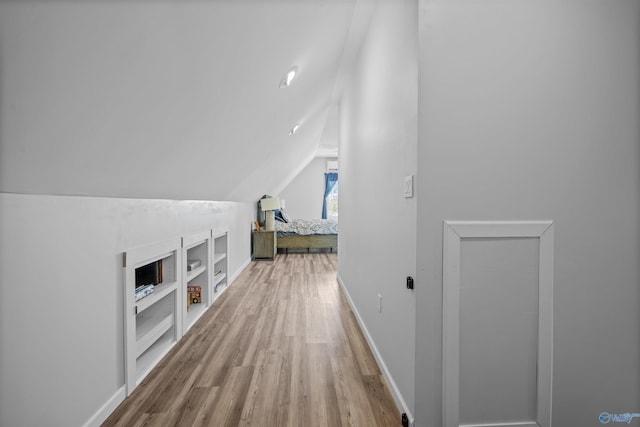 331 Ayers Cir, Grant, AL 35747 - hallway with vaulted ceiling, built in shelves, wood finished floors, and baseboards