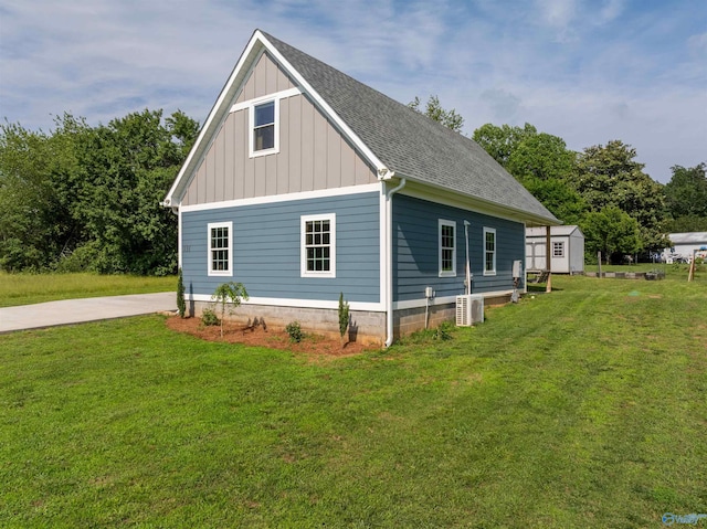 331 Ayers Cir, Grant, AL 35747 - view of property exterior featuring board and batten siding, a yard, roof with shingles, and an outdoor structure