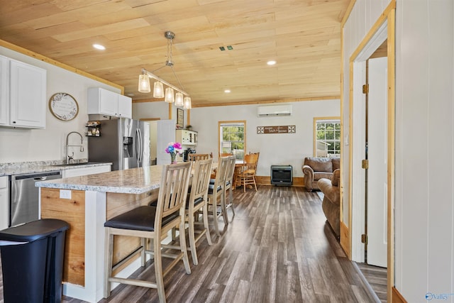 331 Ayers Cir, Grant, AL 35747 - kitchen featuring wood ceiling, stainless steel appliances, dark wood-type flooring, a wall mounted AC, and white cabinets