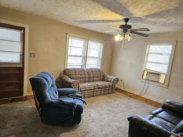 living room featuring carpet floors, cooling unit, baseboards, and a textured ceiling