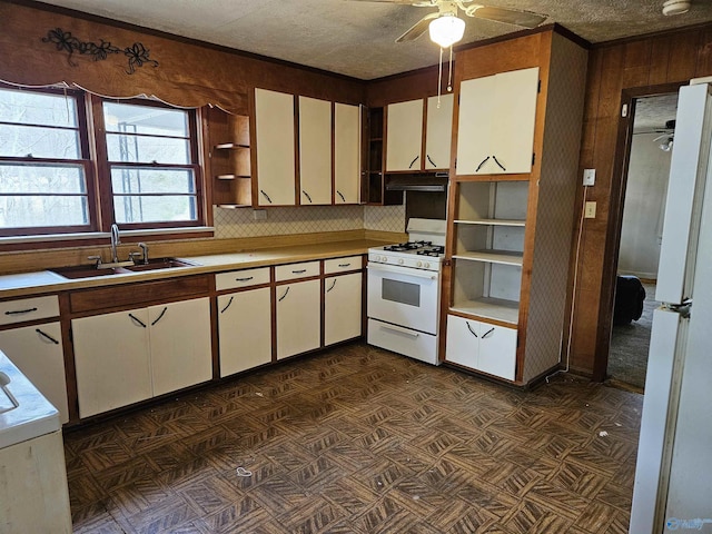 kitchen featuring light countertops, white appliances, a sink, and white cabinetry