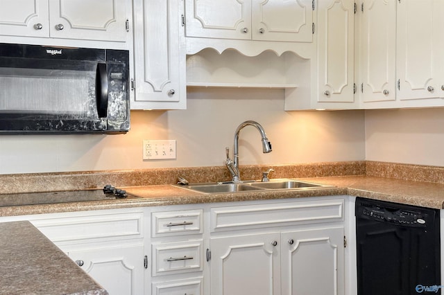 kitchen featuring white cabinets, sink, and black appliances