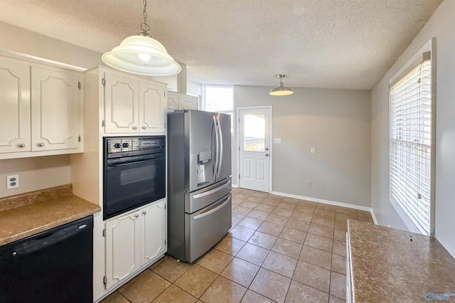 kitchen featuring black appliances, decorative light fixtures, white cabinetry, and light tile patterned floors