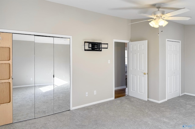 unfurnished bedroom featuring ceiling fan, light colored carpet, and vaulted ceiling