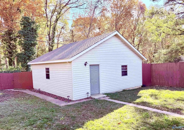 view of outbuilding featuring a lawn