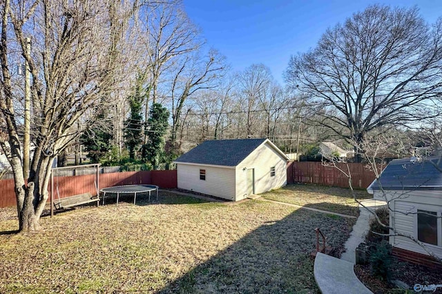 view of yard with an outbuilding and a trampoline