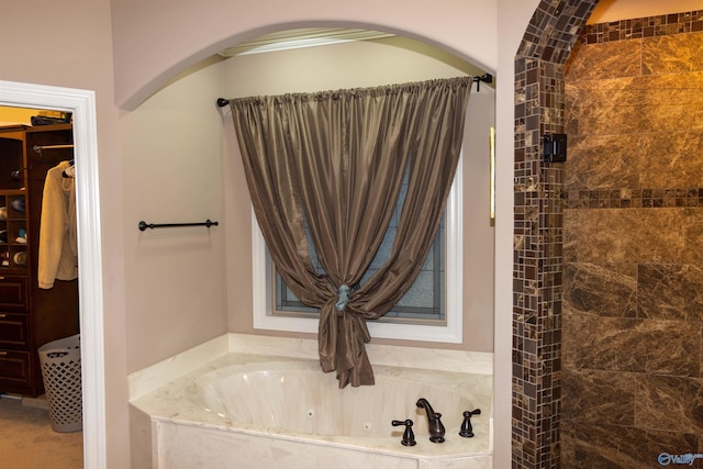 bathroom featuring separate shower and tub