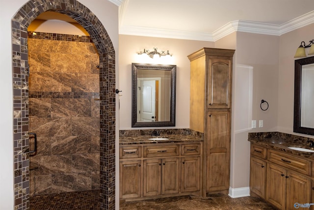 bathroom featuring ornamental molding, a shower with shower door, and vanity