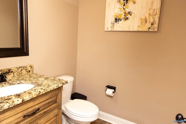 bathroom with toilet and vanity