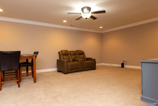 cinema featuring light carpet, ceiling fan, and ornamental molding