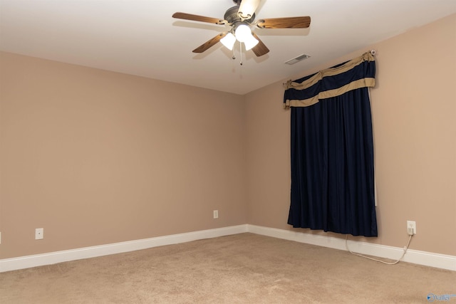 unfurnished room featuring ceiling fan and carpet flooring