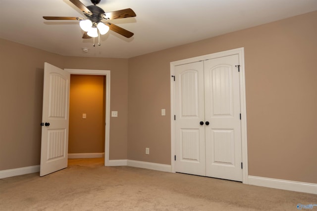 unfurnished bedroom with ceiling fan, light colored carpet, and a closet