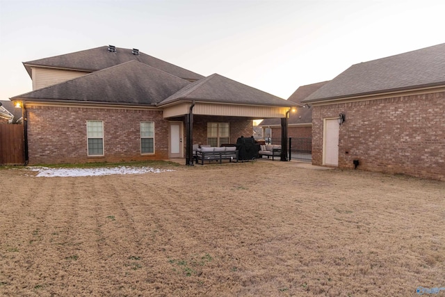 rear view of house featuring a yard