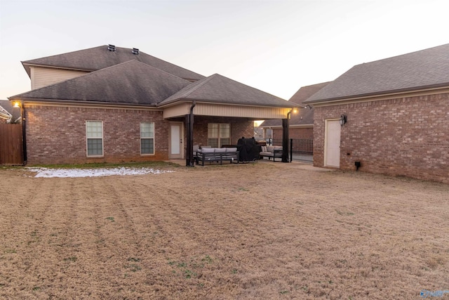 rear view of property with an outdoor hangout area