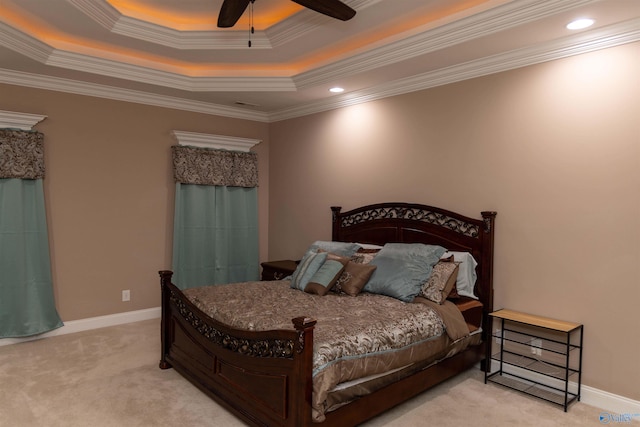 carpeted bedroom with ornamental molding, a raised ceiling, and ceiling fan