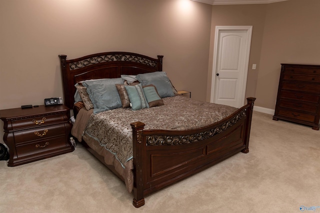 bedroom with light carpet and ornamental molding