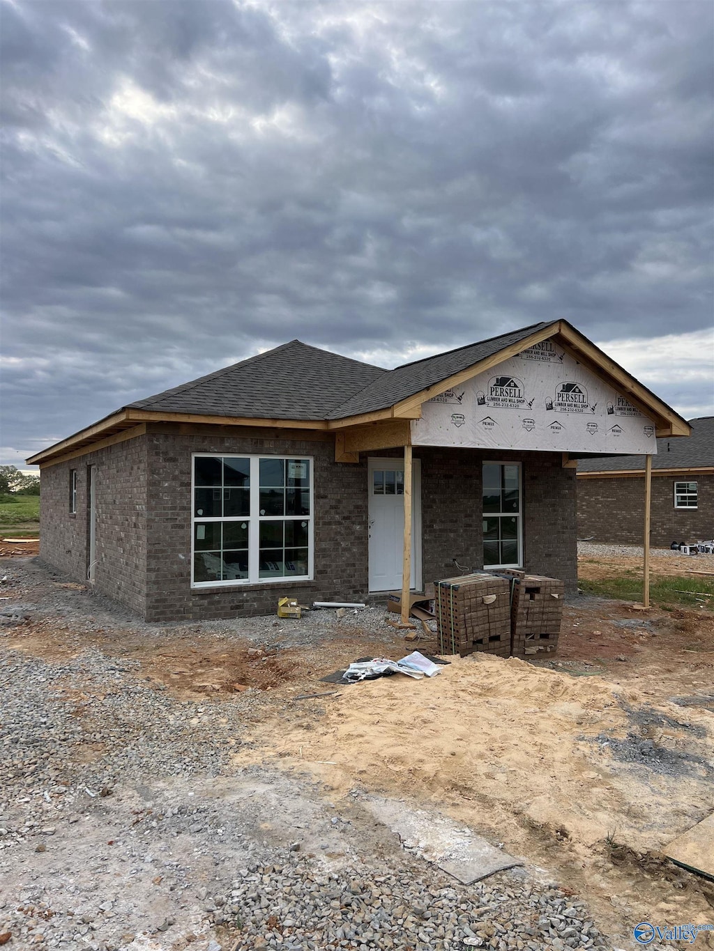 property in mid-construction with brick siding