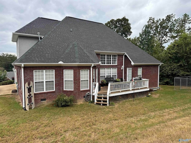 back of property featuring a yard and a deck