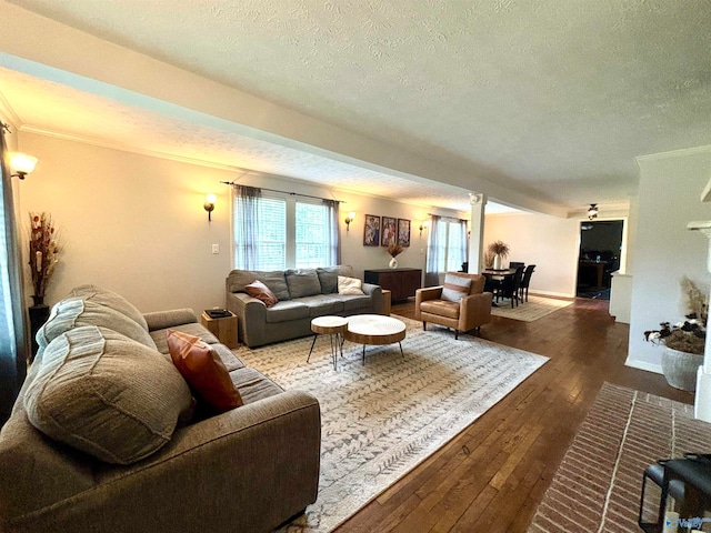 living room with crown molding, a textured ceiling, and hardwood / wood-style floors